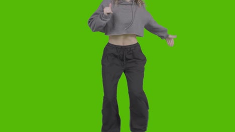 Close-Up-Studio-Shot-Of-Young-Woman-Having-Fun-Dancing-Against-Green-Screen-3