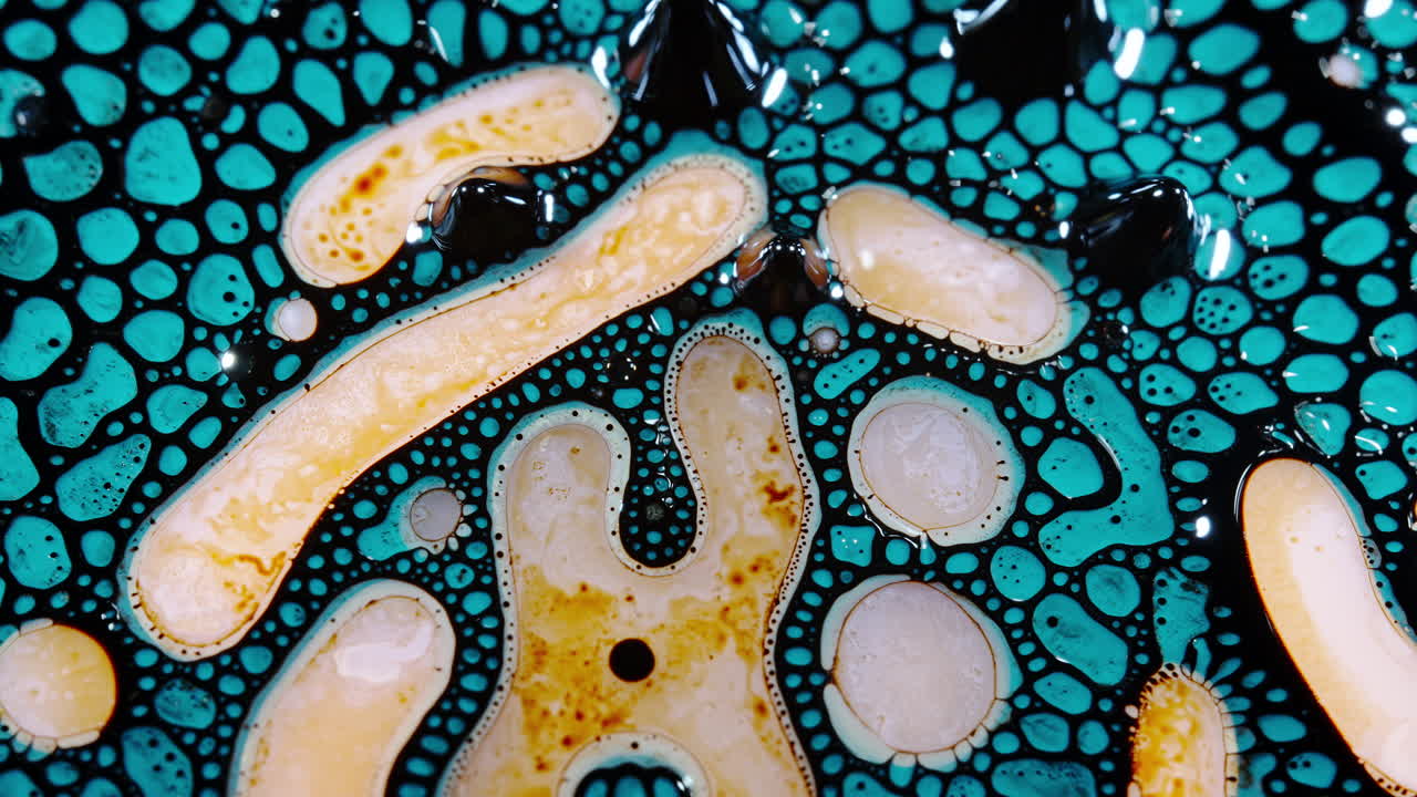 Abstract macro shot of colorful liquid patterns forming organic shapes with vibrant textures