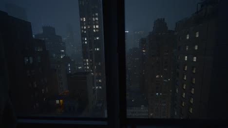 manhattan, new york city view through window at night during a thunderstorm with lightning and rain