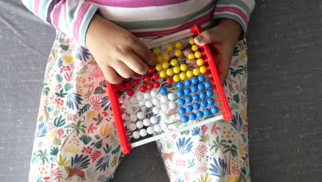 niño jugando con ábaco