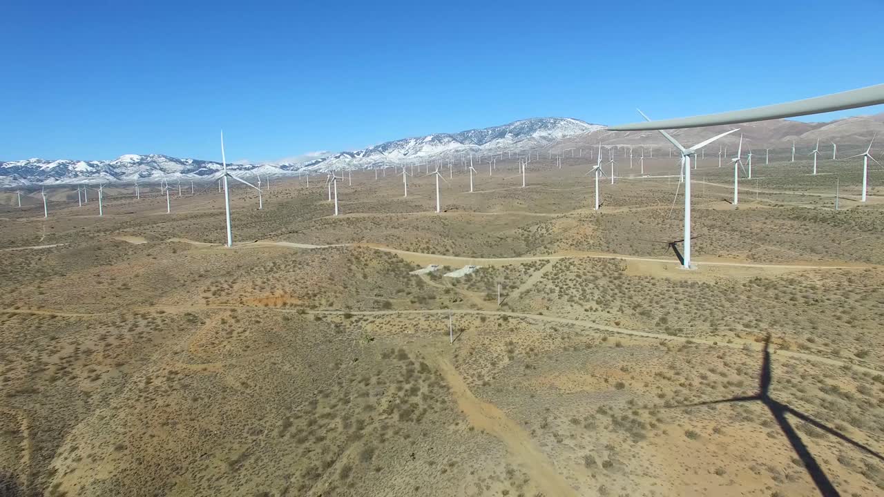 An aerial over a Mojave desert wind farm generates clean energy for California