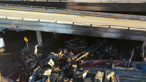 aerial view around burnt pallets under the damaged interstate 10 in los angeles