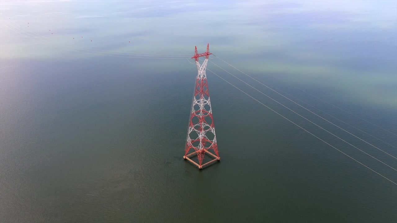 A solitary power transmission tower stands amidst expansive waters, highlighting energy infrastructure. Suitable for projects on energy, engineering, or environmental studies.