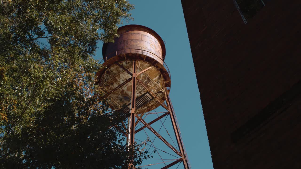 Low angle showing old coal factory tower building in old village during blue sky