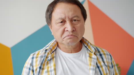 displeased older asian man