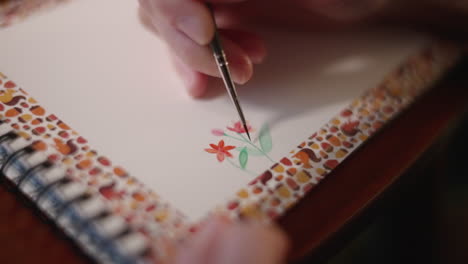 skilled woman painting flowers using watercolor on a sketchpad in tokyo, japan