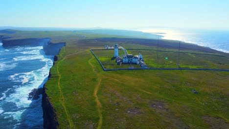 vista aérea cercana de un faro en un acantilado mientras gira a la izquierda