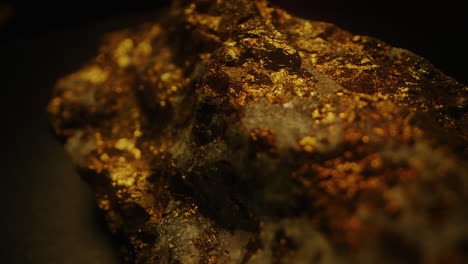 raw gold ore against a dark background - close up