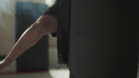 dynamic man athlete strikes suspended punching bag with leg in premise for boxing. energetic way of life and enhanced physical condition of male body