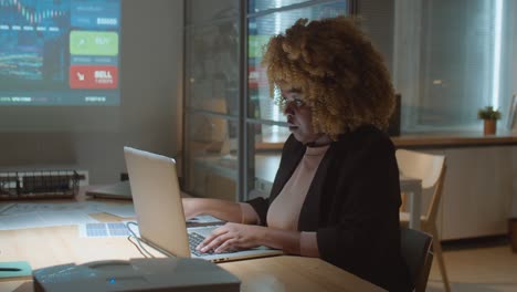 black businesswoman working late in office