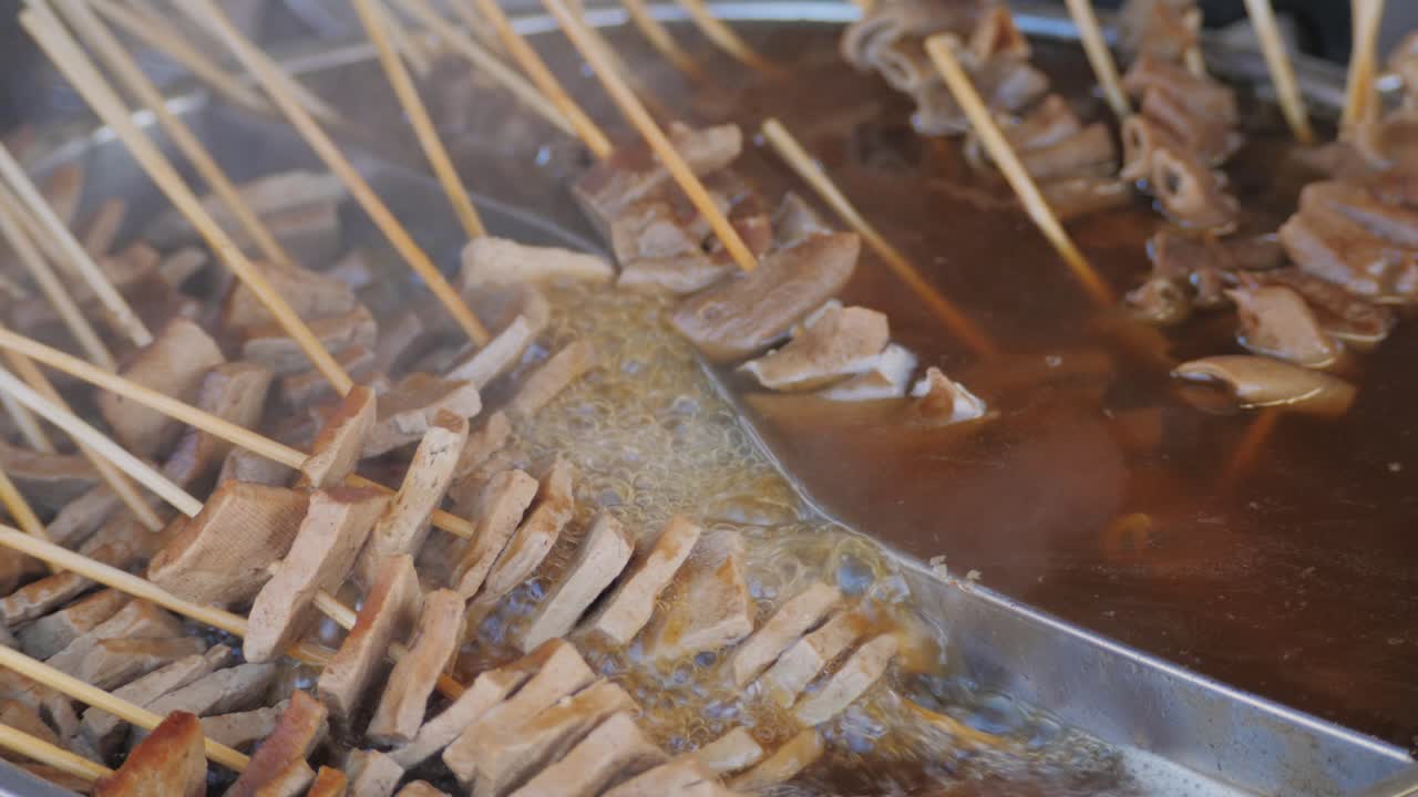 Traditional chinese spicy chicken gizzards close-up. Asian chicken stomach popular food. Local street food market outdoor. High quality 4k footage