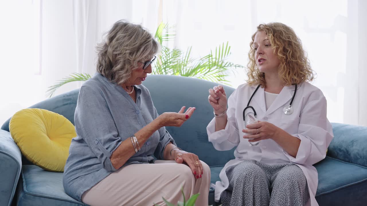 Doctor giving pills to senior patient