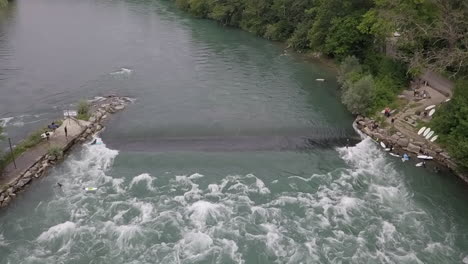 weir on reuss river in bremgarten switzerland creates surfing wave