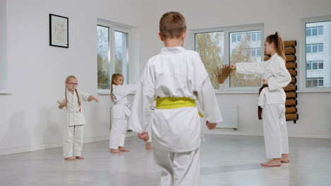 pupils and teacher in white kimono in martial arts class