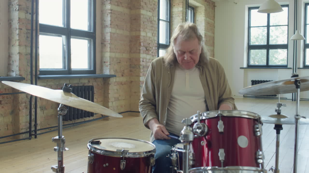 Old Drummer Playing Drums in Studio
