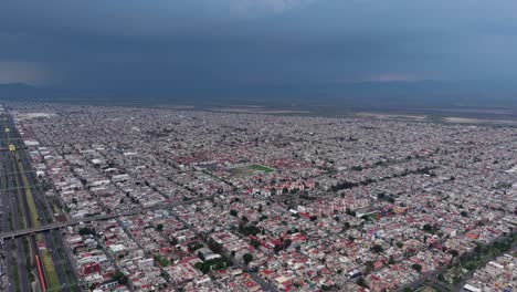 northern mexico city under a dark, rainy storm, captured by drone