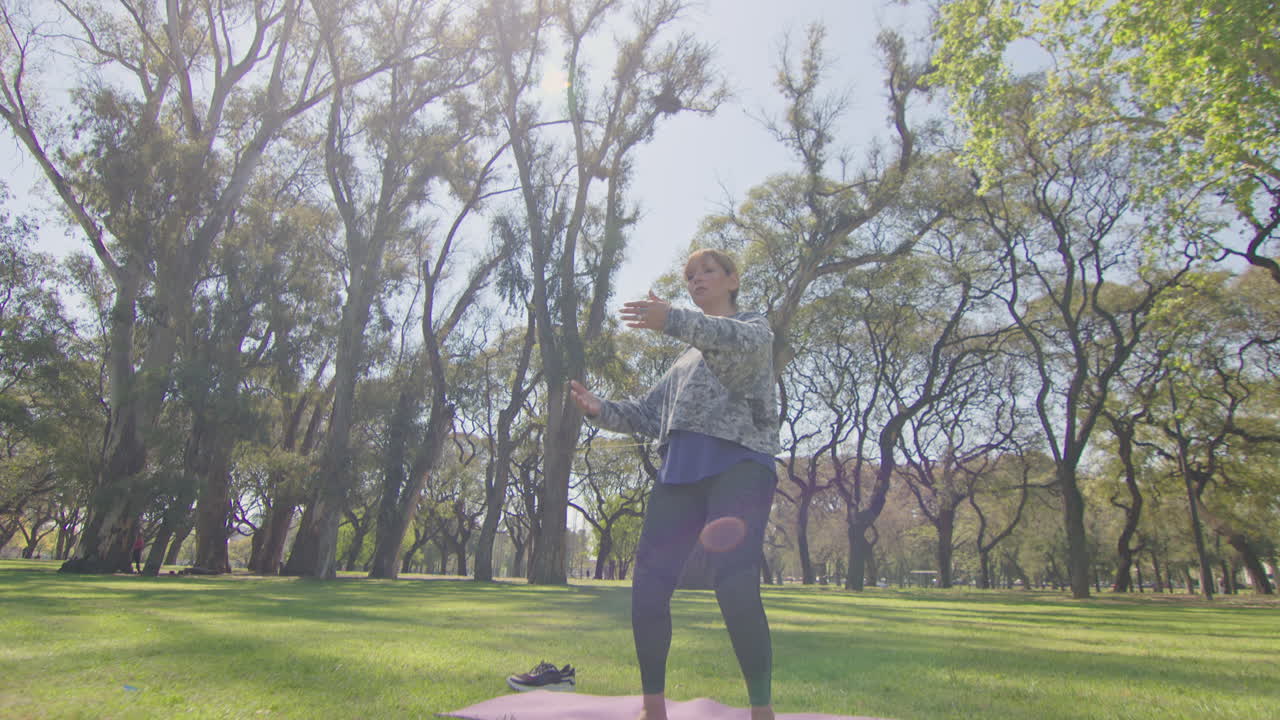 Woman Practicing Tai Chi in a Park