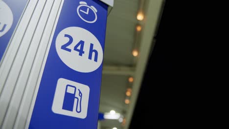 24h open sign located on a petrol station at night