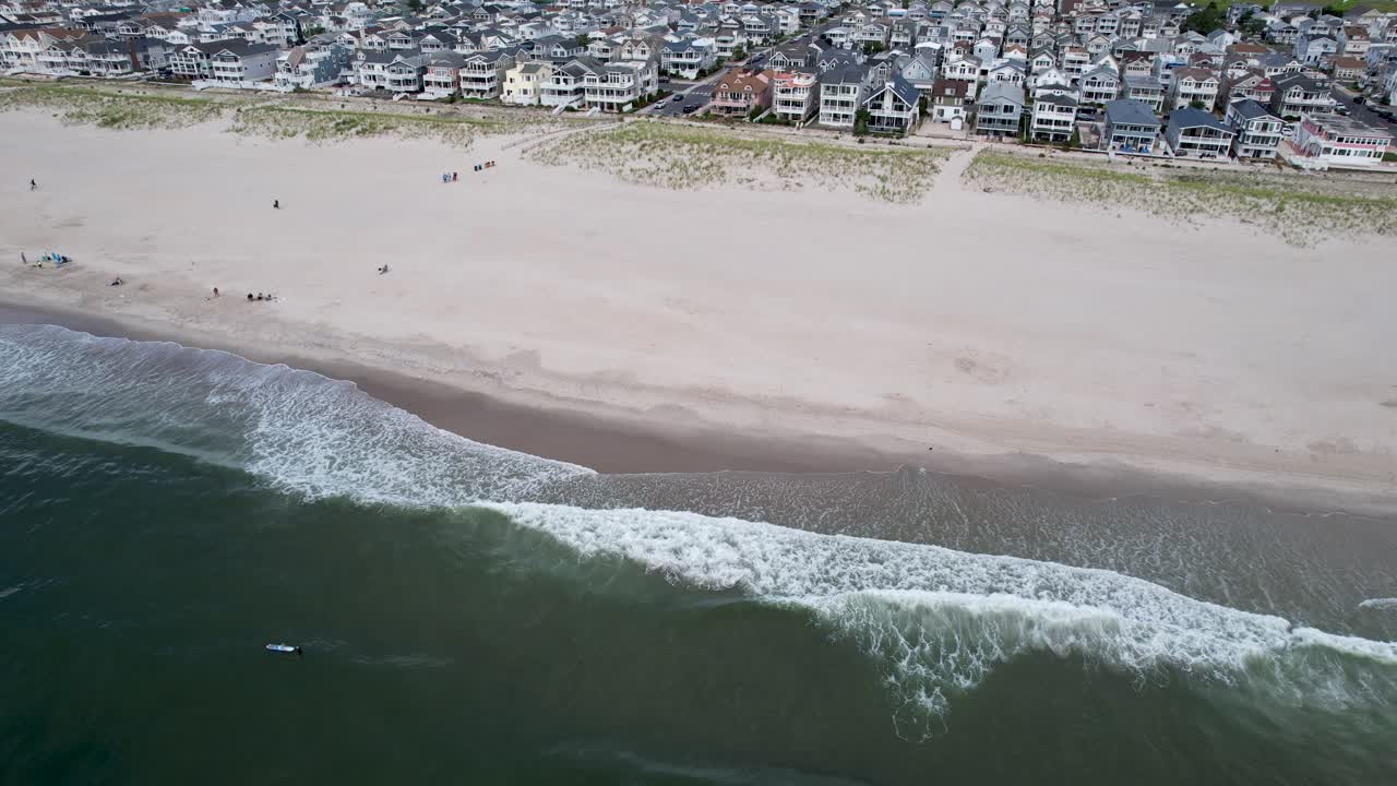 vista aérea de un surfista esperando atrapar la ola perfecta en la costa de jersey