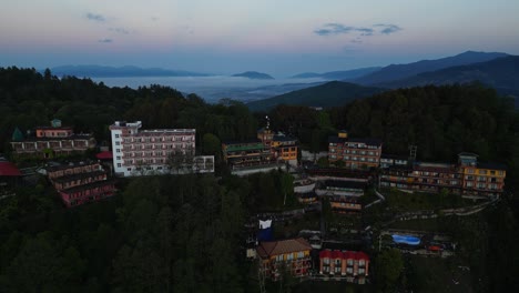 aerial footage of clouds and hills emerging behind urban landscape (high-res footage)