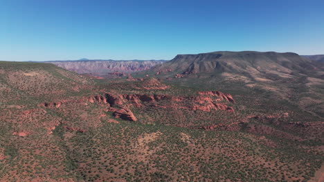 drone se mueve hacia adelante en una amplia toma del desierto de sedona con formaciones de roca roja