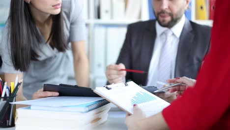 business partners studying graphs on documents closeup 4k movie slow motion