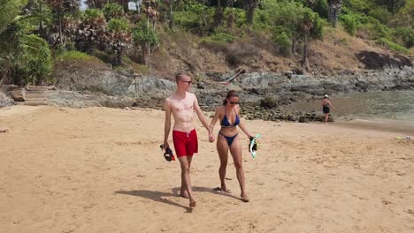 couple snorkeling on a tropical beach