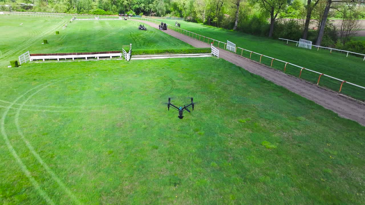 Industrial cinema line drone fly above green field on sunny day, Czechia