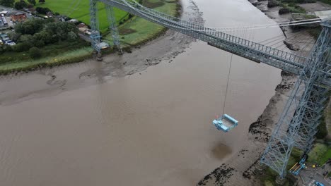 Newport-transporter-bridge-and-gondola-industrial-River-Usk-landmark-aerial-pull-back-tilt-up-view