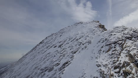 aerial shot of steep snowy mountain wall