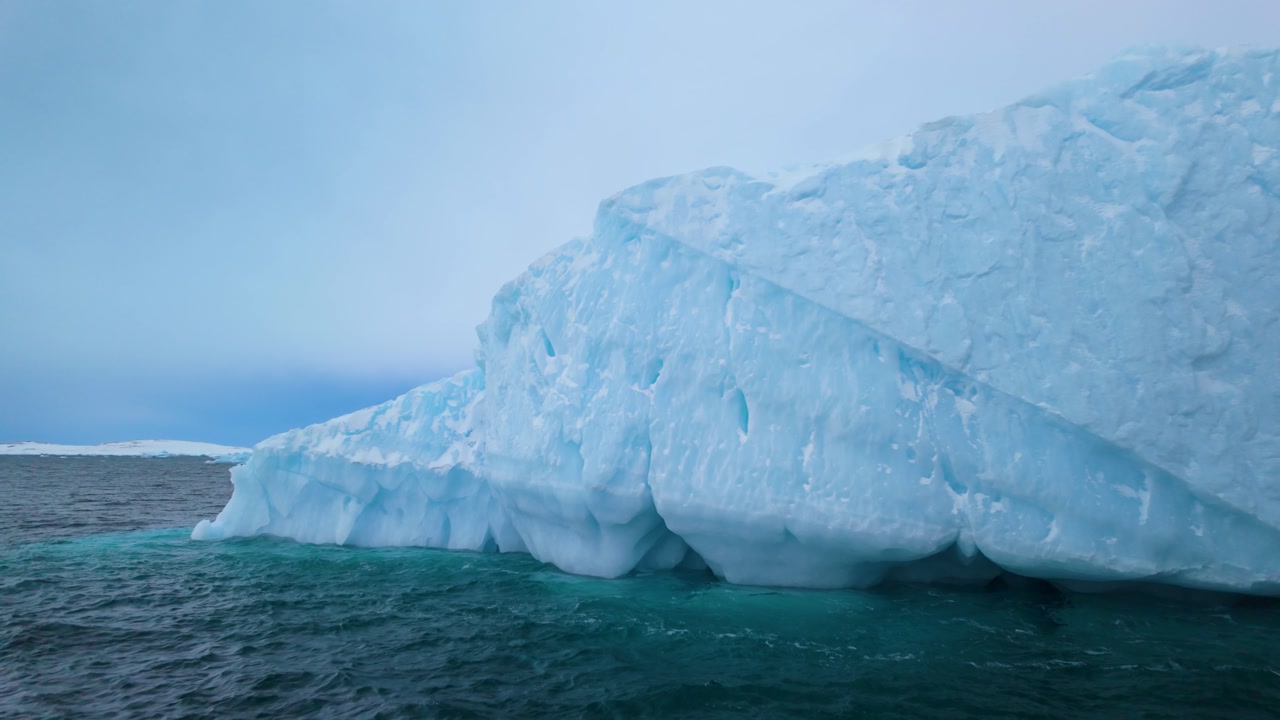 Wavy Arctic Sea water by melting iceberg in Greenland seen from boat