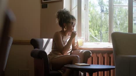 fashionable african woman drinking lemonade