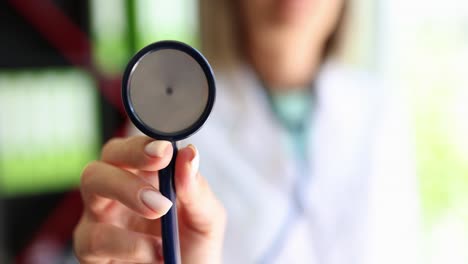 close-up of a medical professional holding a stethoscope