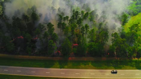 raging forest fire inches toward highway in georgia – aerial view from america