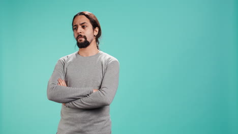 grumpy man crossing arms, feeling upset by events
