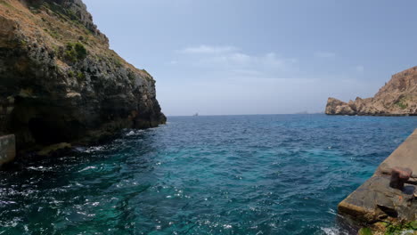 view one of the spectacular sunsets near mellieha bay from the famed popeye village theme park malta, with its cliff-lined coastline and scenic inlets