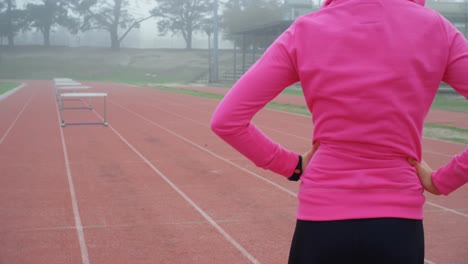 female athlete standing on a running track 4k