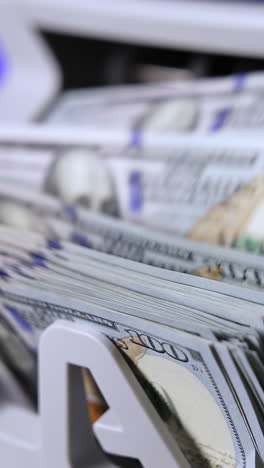 bank cash counter machine with a lot of dollars. finance business money counting. cropped view. money concept vertical video