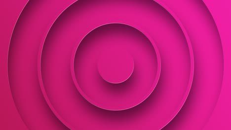 círculos concéntricos que se forman sobre un fondo rosado