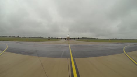 a vehicle drives in front of a large aircraft to give it guidance on where to go and where to park.