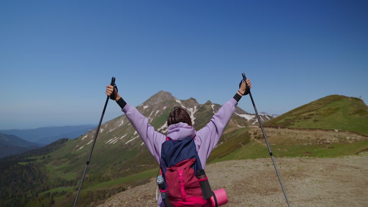mujer excursionista alcanza la cumbre de la montaña