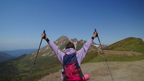 woman hiker reaches mountain summit