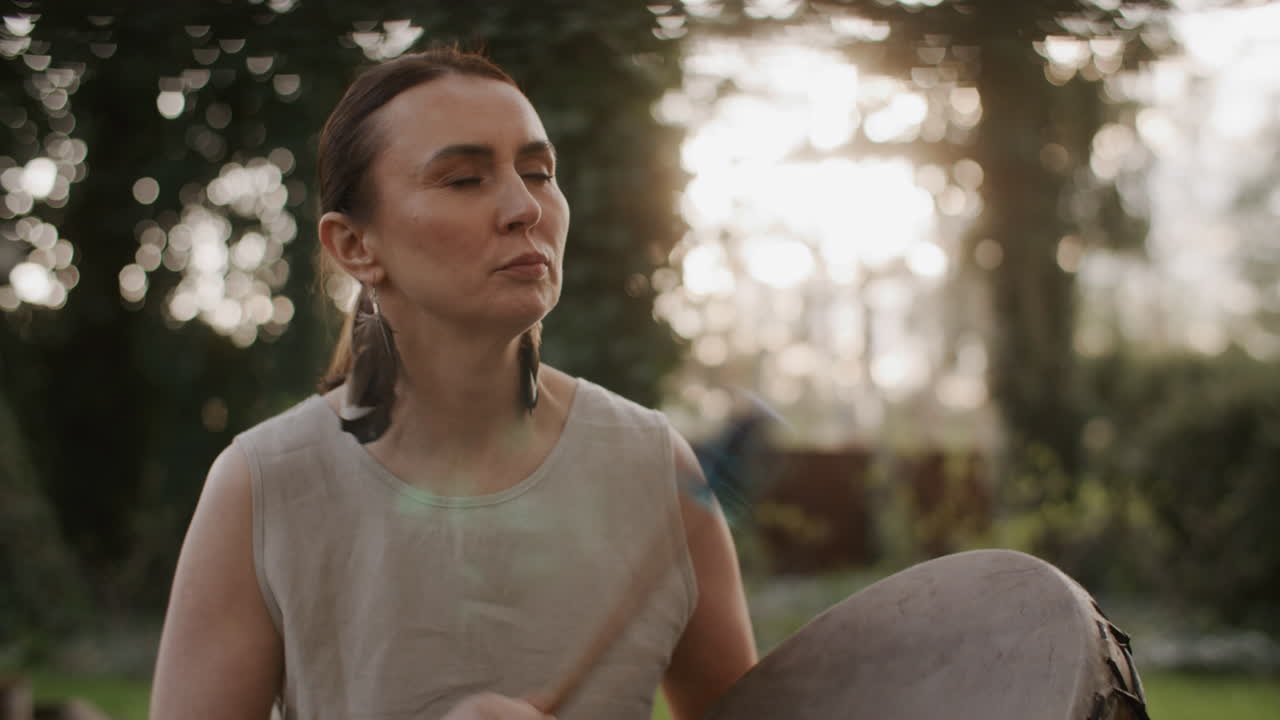 Woman Playing a Drum Outdoors