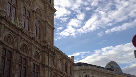 tilt down over old historical building in european city center on blue sky cloudy day