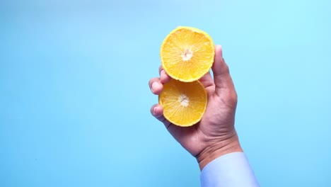 hand holding sliced orange