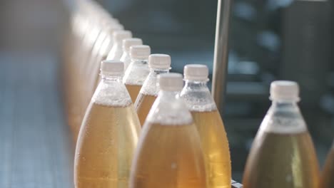 conveyor belt with bottles for juice or water at a modern beverage plant. modern production of sweet soda water