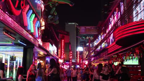 colorful lights and crowds in a lively city scene