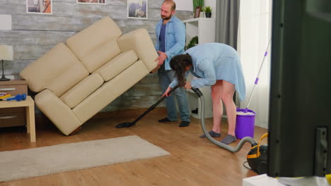 man lifting the sofa for cleaning