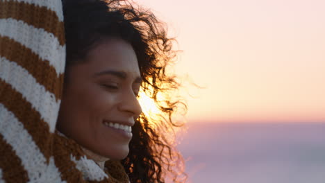 portrait of beautiful hispanic woman enjoying peaceful seaside at sunset exploring mindfulness contemplating spirituality with wind blowing hair