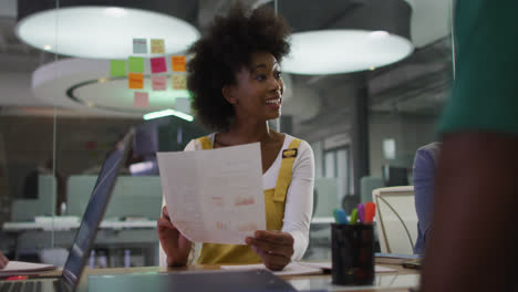 Mixed-race-business-colleagues-sitting-having-a-discussion-in-meeting-room